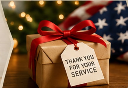 A wrapped gift tagged "Thank You For Your Service," with a Christmas tree and American flag behind it.